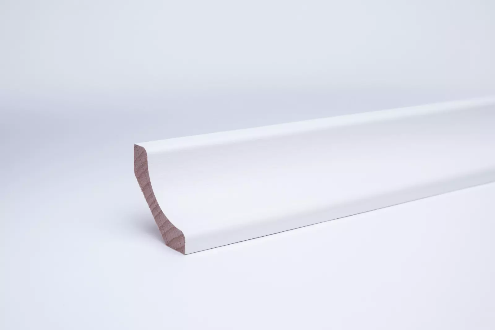 Real wood skirting as coved profile in white varnished